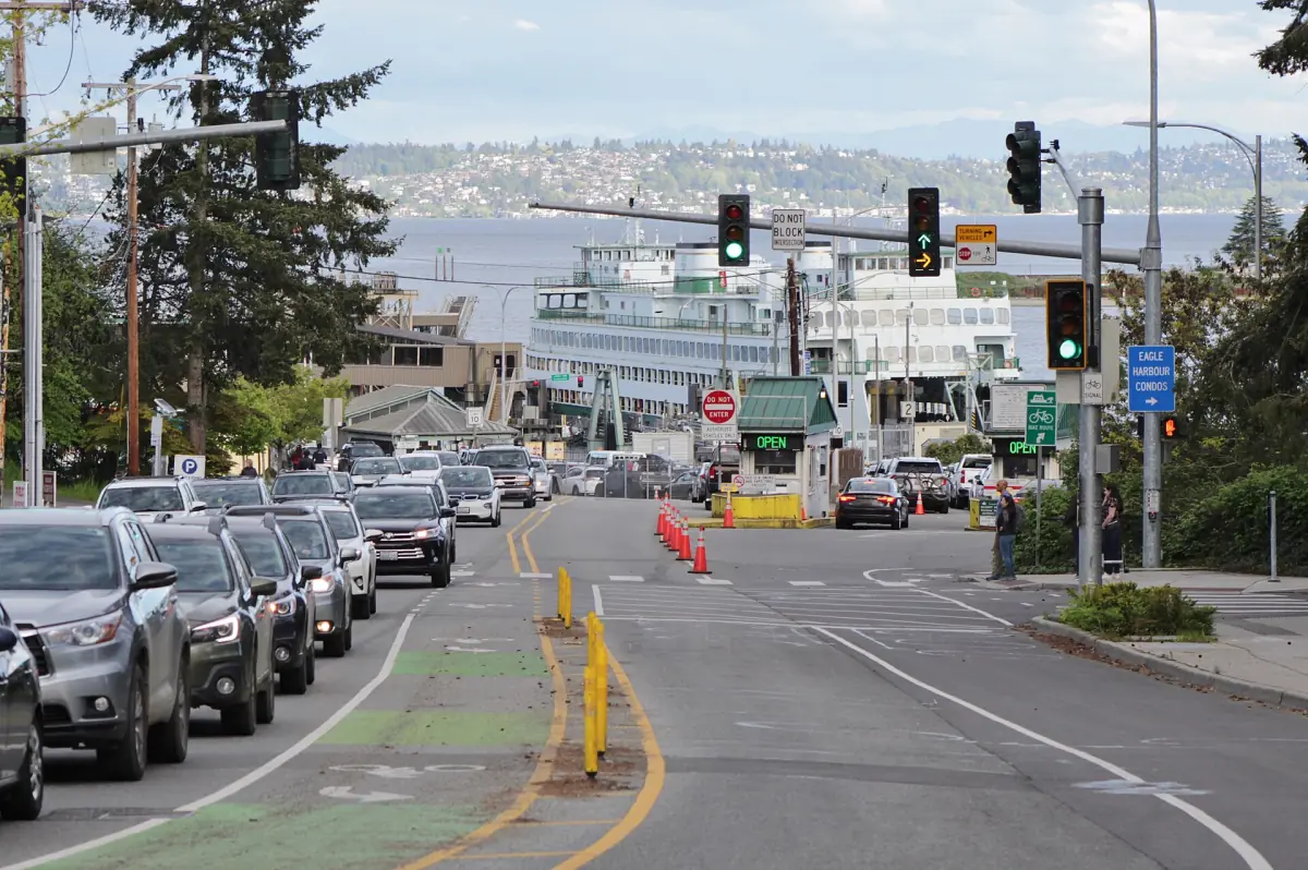 Cars leaving and lining up near the ferry terminal on a sloping road