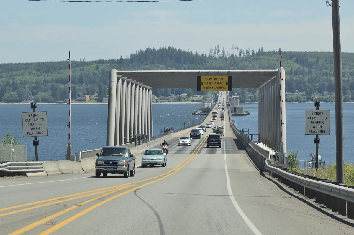 Roadway of the floating Hood Canal Bridge with a raised span ahead