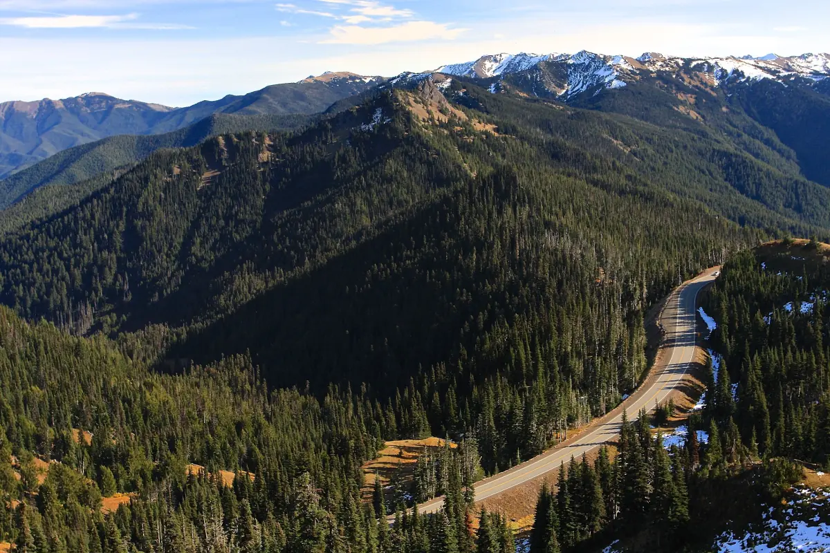 Mountain ridges and forested valley with a winding road at Hurricane Ridge
