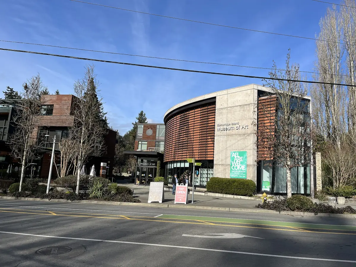 Museum building at a street corner with bare trees in winter light
