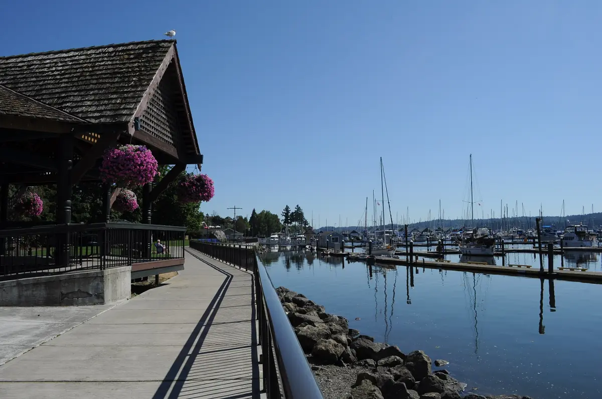 Waterfront promenade with a wooden pavilion beside the harbor