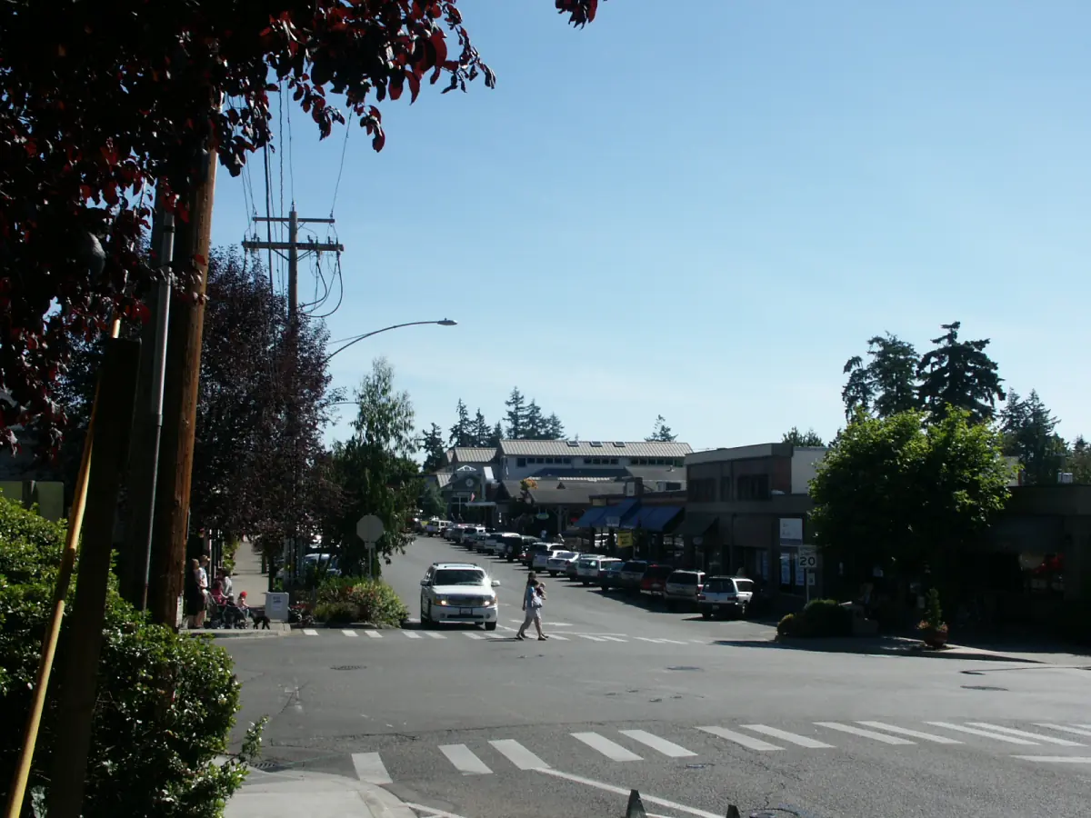 Street scene along Winslow Way with shops and trees on a sunny day